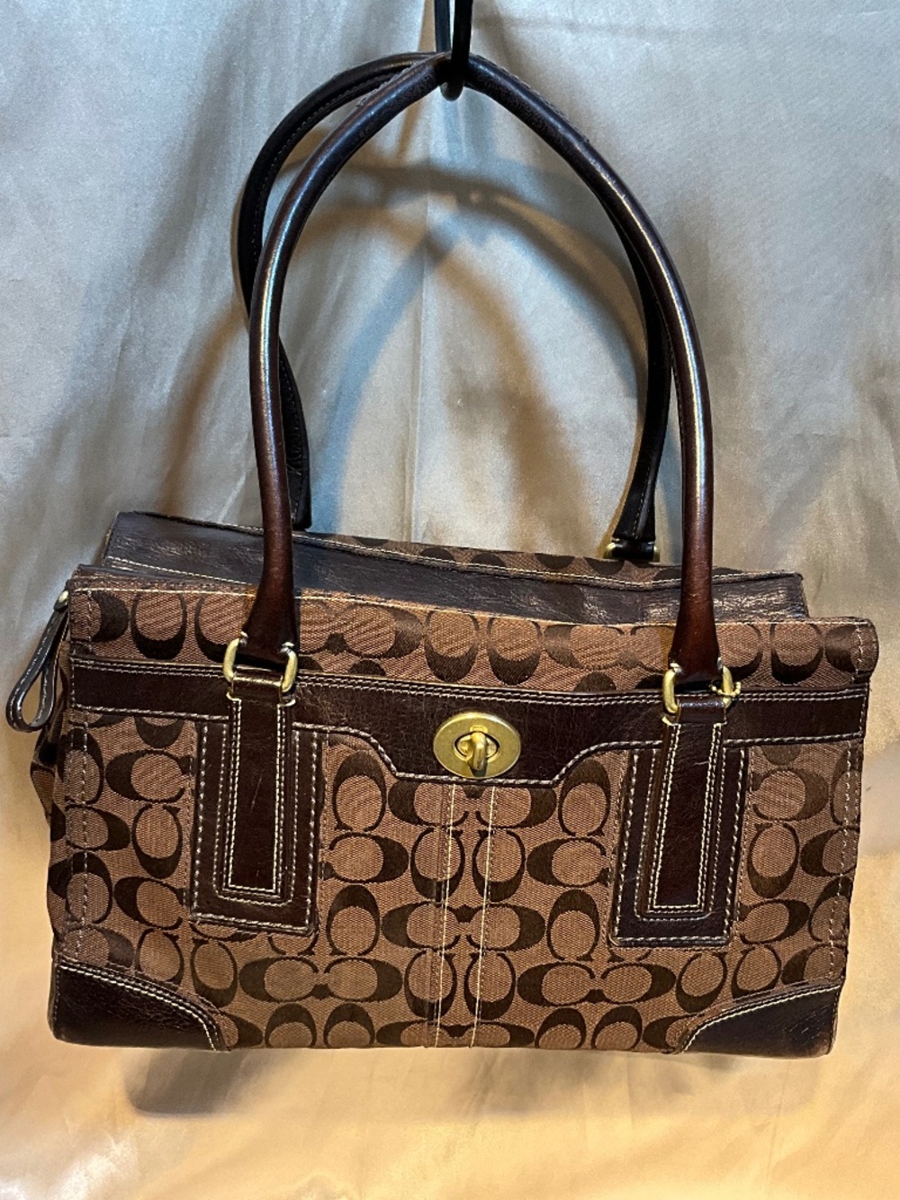 Coach handbag dark brown on light brown signature print.      H7H